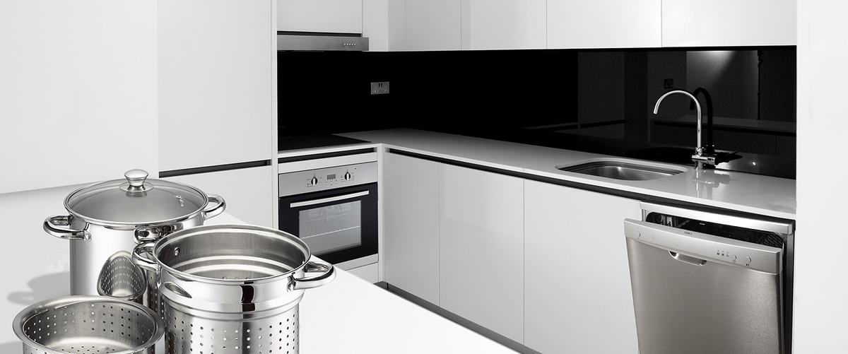 A modern white kitchen with a Viali rangehood, oven, dishwasher and stainless steel stockpots
